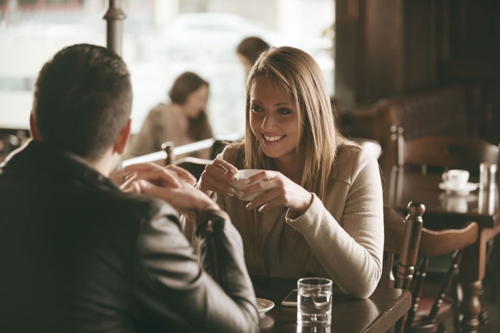 36918315 - young couple at the bar having a coffee and flirting