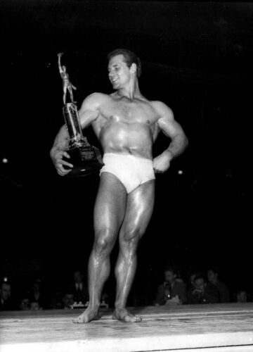 John Grimek of York, Pa, displays the torso, and the trophy his torso won for him at the 1940 weight lifting championships at Madison Square Garden in New York May 26, 1940. Grimek was judged the "best developed and proportioned amateur athlete", and was awarded the title "Mr. America." (AP Photo)