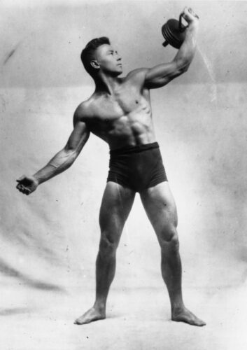 circa 1940: A bodybuilder lifting weights. (Photo by General Photographic Agency/Getty Images)