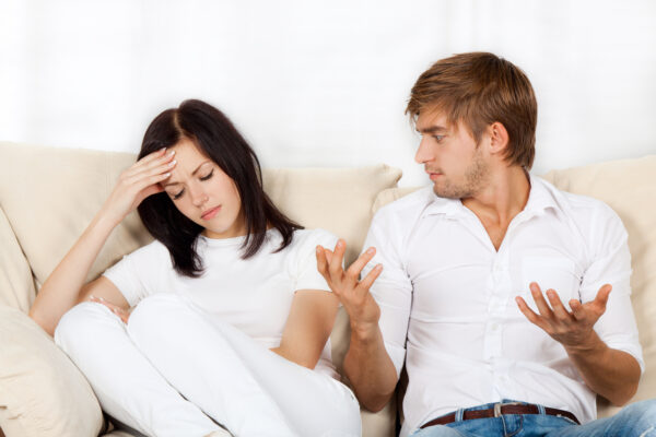 beautiful young couple conflict sitting on a couch argue unhappy, portrait young man and woman