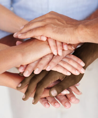 Closeup portrait of a group of people's hands together