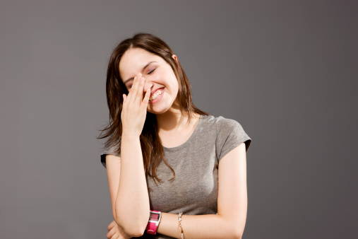 Girl Laughing With Hand On Face