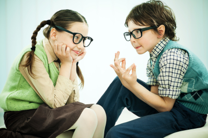 A girl and a boy wearing big black glasses are talking.  [url=https://www.istockphoto.com/search/lightbox/9786682][img]https://dl.dropbox.com/u/40117171/children5.jpg[/img][/url]