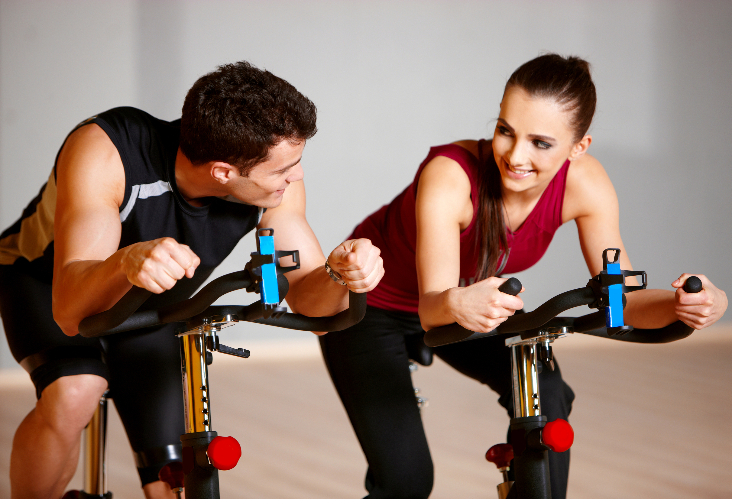 Sporty couple exercising at the fitness gym