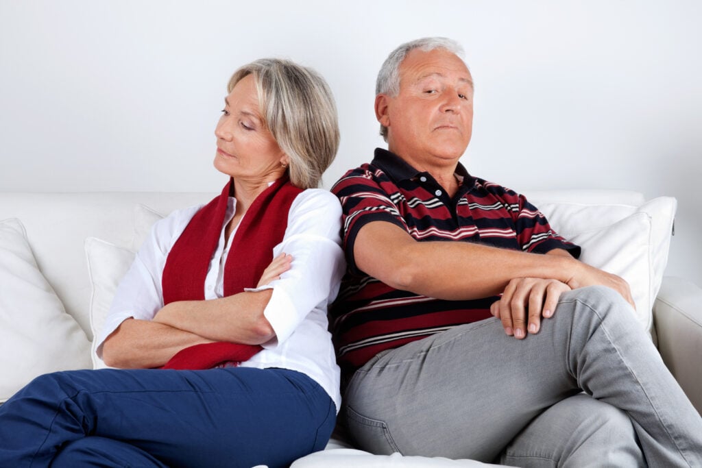 Senior couple sitting on sofa after argument