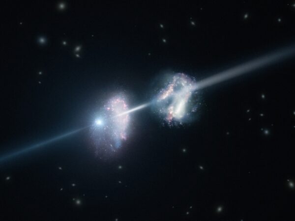 This artistÕs impression shows two galaxies in the early Universe. The brilliant explosion on the left is a gamma-ray burst. The light from the burst travels through both galaxies on its way to Earth (outside the frame to the right). Analysis of observations of the light from this gamma-ray burst made using ESOÕs Very Large Telescope have shown that these two galaxies are remarkably rich in heavier chemical elements.
