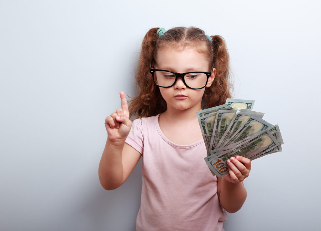 Small kid holding dollars and have an plan how earning